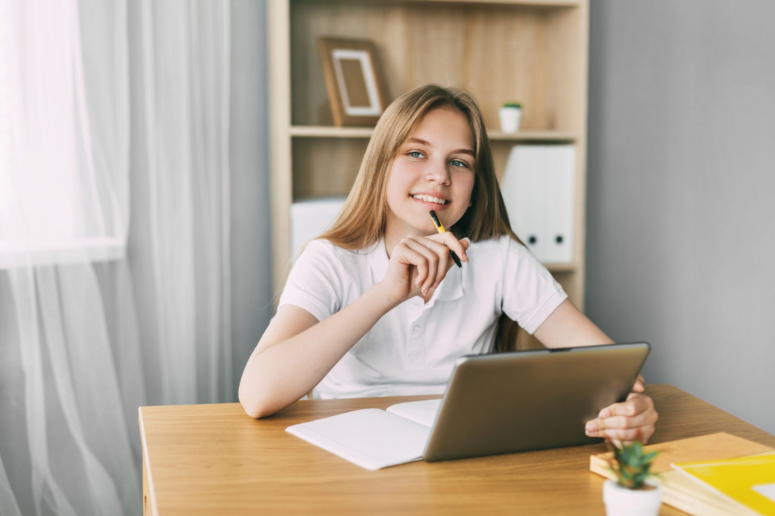 a thoughtful girl sits at a desk and prepares for P7TKHLD scaled