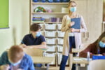 teacher and students in masks during exam in the c BURG7HM