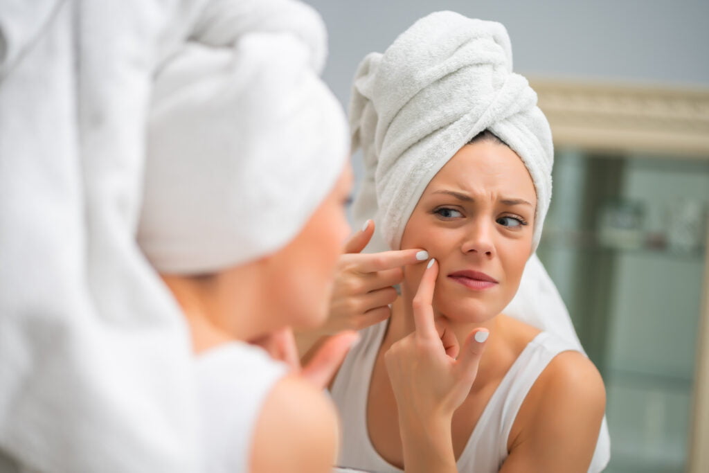 woman squeezing pimple 2021 08 27 13 48 47 utc