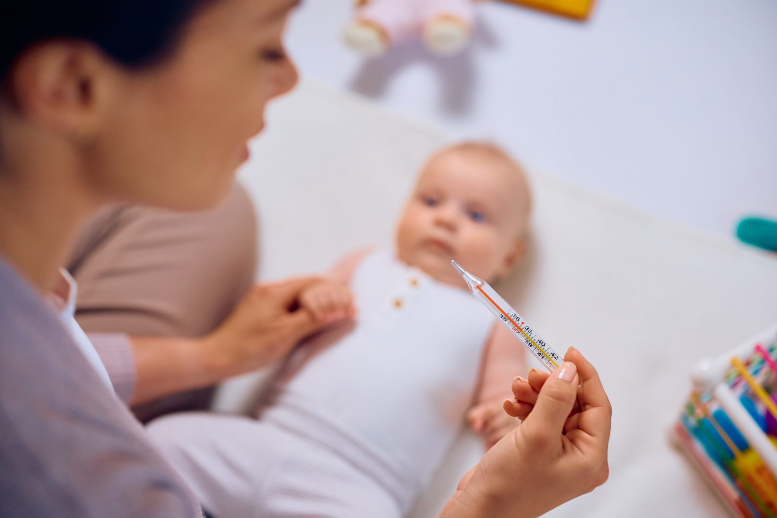 close up of mother checking her baby s body temper 2024 12 13 22 03 48 utc scaled